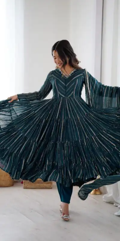 SRK 5305 Peacock Blue Color Mal Chanderi Gown with Mirror Work & Lace Work. Grab it for ₹2399. Delivery 4-6 Working Days. Shop now. | Bollywood Gowns, Creative Gowns, Designer Gowns, Embroidered Gowns, Gowns, Party Wear Gowns